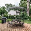 Outsunny 5 Pieces Garden Dining Set for 4, Cast Aluminium Outdoor Dining Set with 4 Armchairs and Round Dining Table with Parasol Hole, Garden Furniture Set, Brown