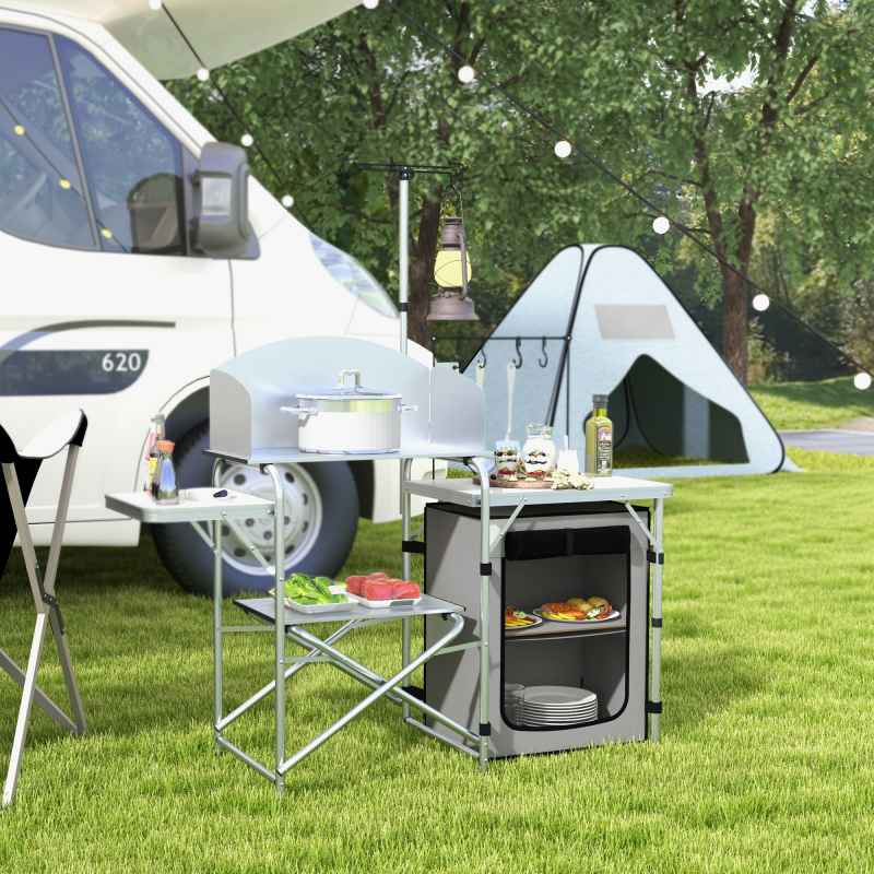 Outsunny Camping Kitchen with Storage Cupboard, Folding Camping Table, Aluminium Portable Picnic Table with Windshield, Light Stand, Carrying Bag for BBQ, Silver